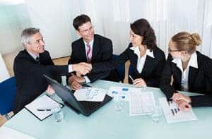 Group of professional advisors sitting in a meeting room in black attire